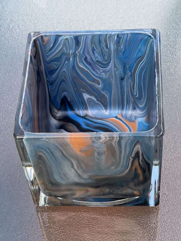 a glass container with a colorful pattern
