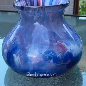 a blue and white vase on a table