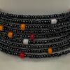 Adjustable black, white and orange beaded bracelet